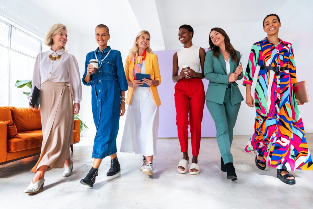 Group of beautiful confident businesswomen meeting in the office - Multiethinc female creative team brainstorming at work - Diverse colleagues working together  in workshop  in a co-working space